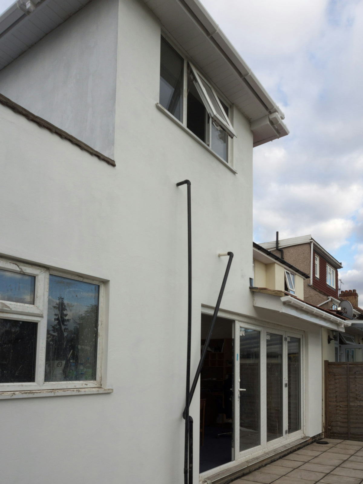 White rendered house with new windows and glazed doors